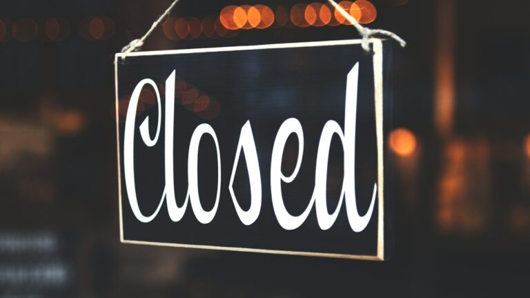 A closed sign on a shop door